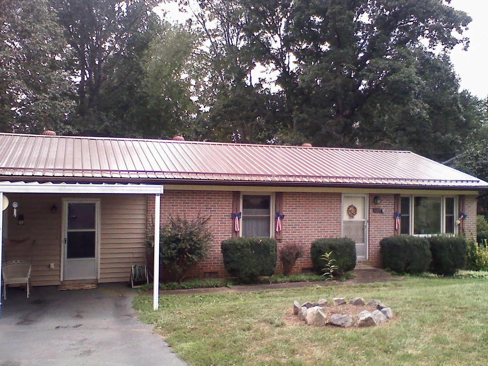 Bronze metal roof and carport on a brick ranch home — Roof Repair work by our crew in Bensenville